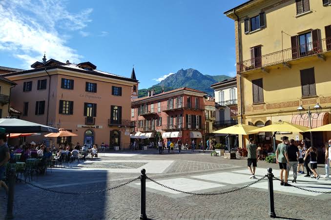 Cafe tables and umbrellas in Menaggio's Piazza Garibaldi