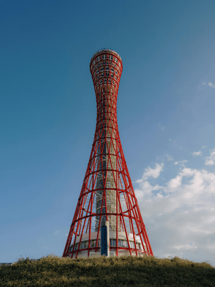 Kobe Port Tower's red lattice hourglass shape against a blue sky