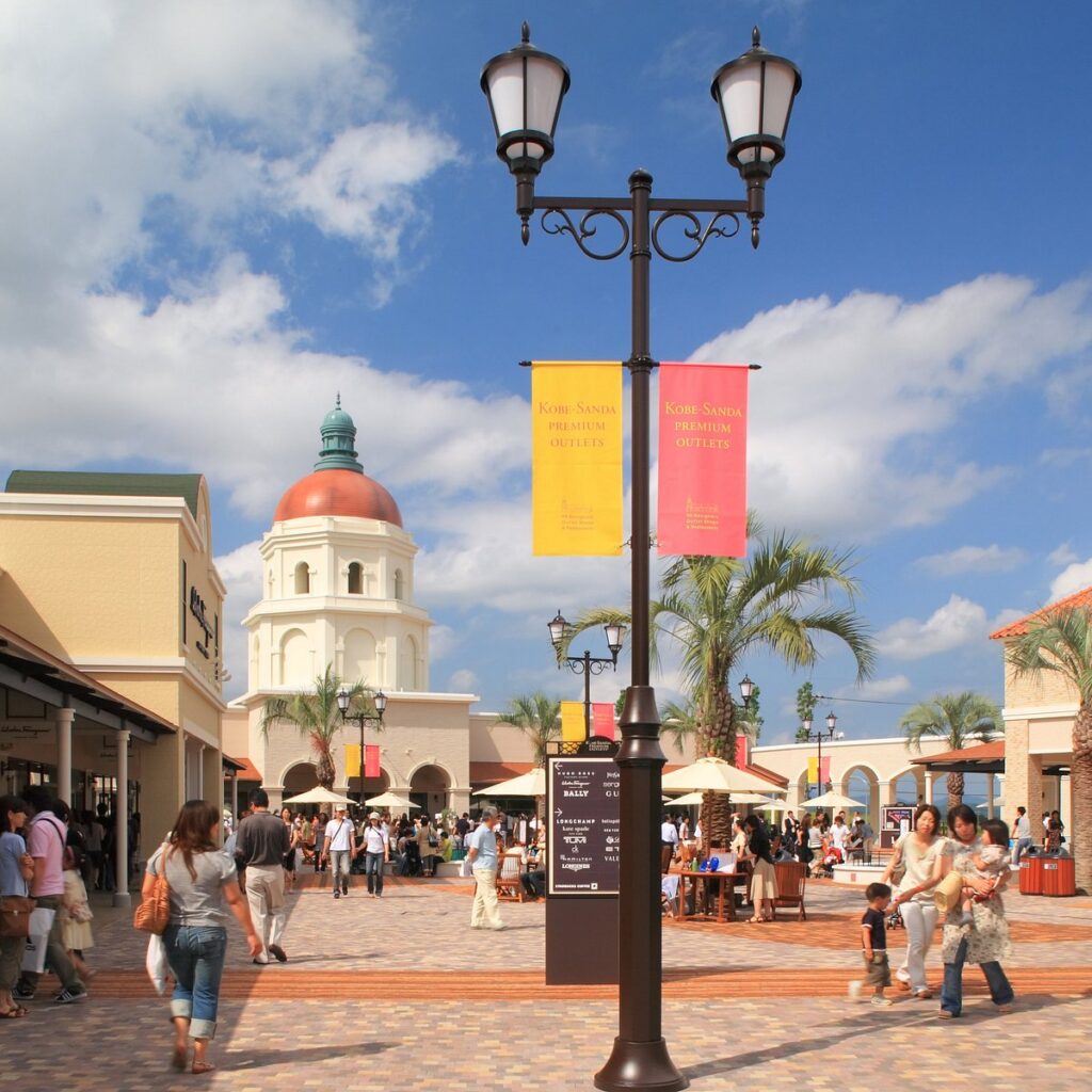 Shoppers in the New England-style plaza at Kobe-Sanda Premium Outlets