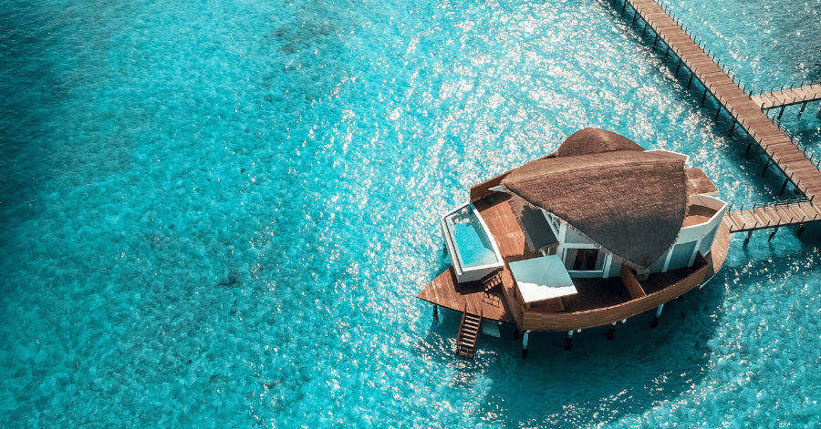 Aerial view of a private overwater villa with a plunge pool in the Maldives