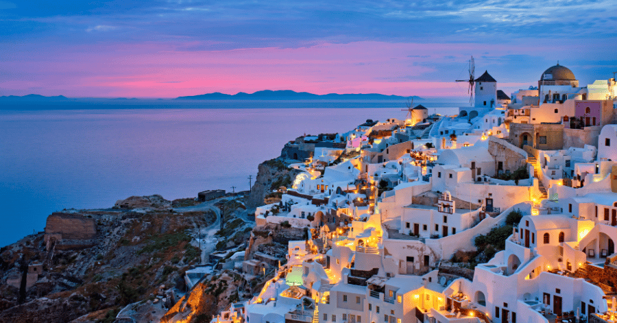Santorini's whitewashed village of Oia overlooking the caldera at dusk
