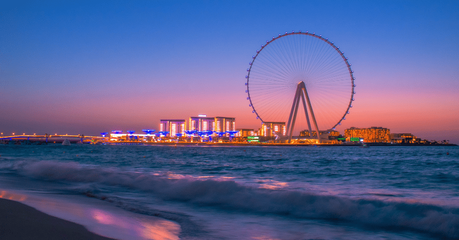 Ain Dubai observation wheel lit up at sunset, seen from JBR beach