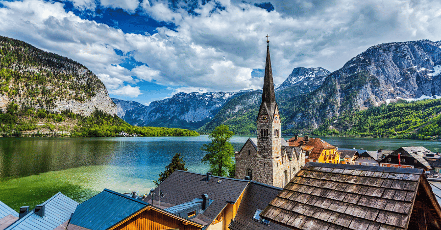 Hallstatt's church spire and lakeside rooftops below steep grey mountains