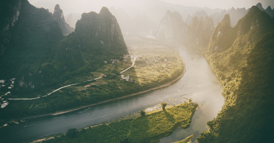 Aerial view of karst peaks lining a bend in the Li River near Guilin