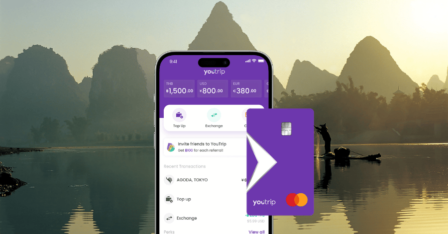 The YouTrip app showing multiple currency balances and card, overlaid on a Li River scene with a cormorant fisherman