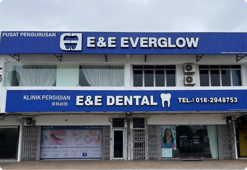 Blue two-storey shopfront with E&E Dental and E&E Everglow signs and a phone number on the lower sign