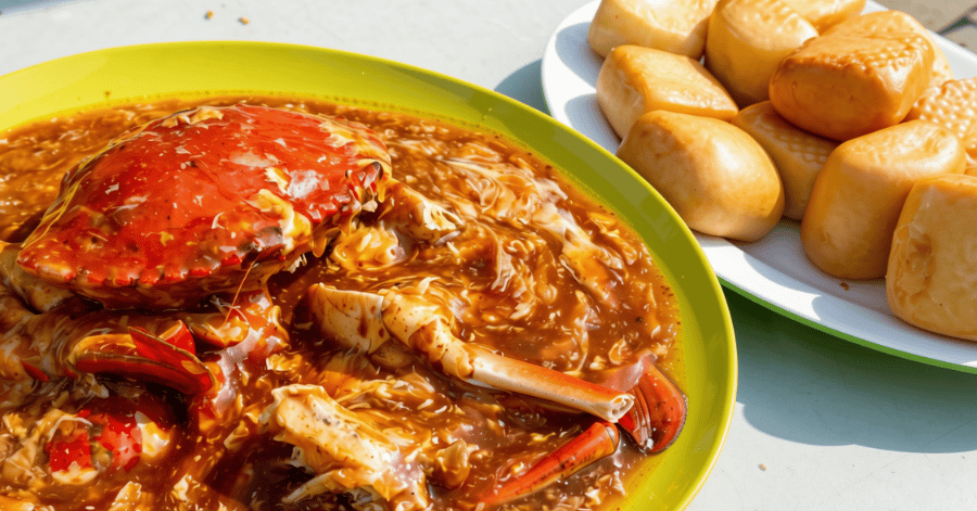 A whole chilli crab in thick gravy served with fried mantou buns on the side