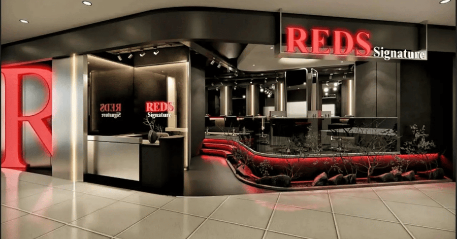 REDS Signature hair salon's illuminated red signage and reception at KSL City Mall