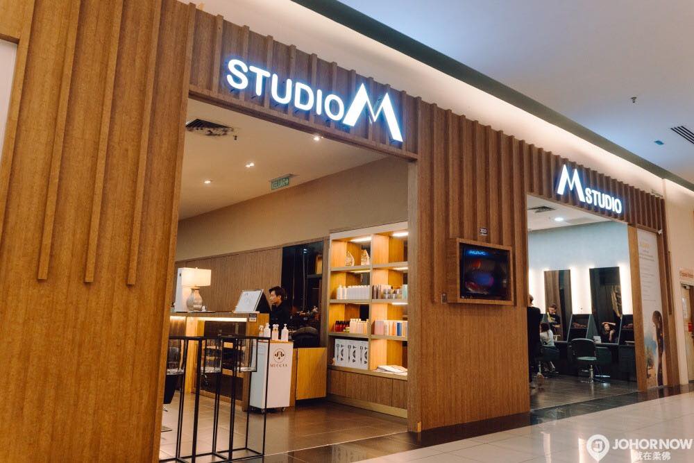 Studio M hair salon's wood-panelled entrance and product display at KSL City Mall