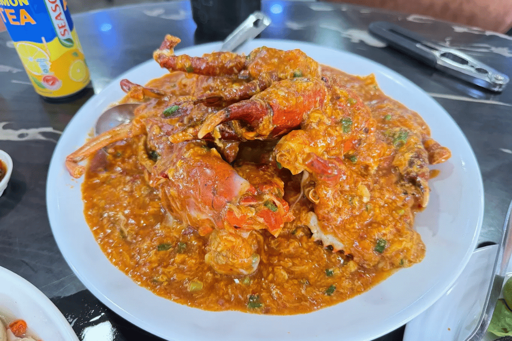 A whole chilli crab in thick orange-red gravy at Tian Lai Seafood Garden, Gelang Patah