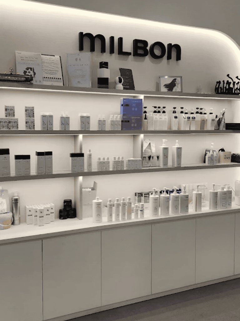 Shelves of Milbon hair-care products on display at U Salon Eco Botanic