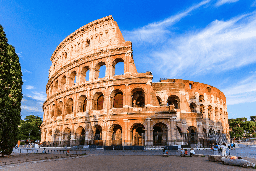 The Colosseum's tiered stone arches lit by late afternoon sun