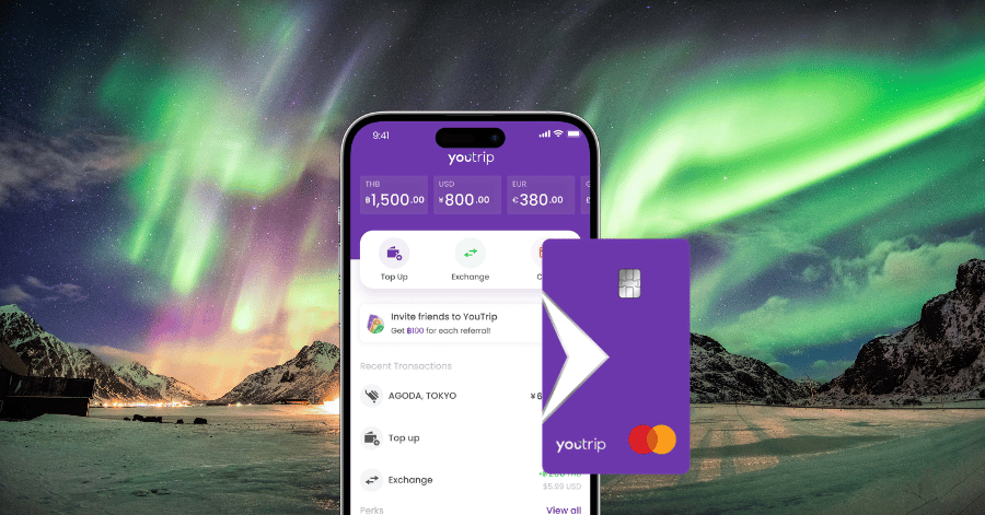 YouTrip app screen and purple YouTrip card in front of the northern lights over snowy mountains