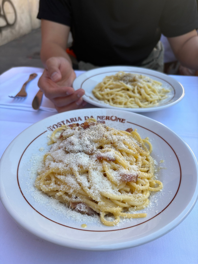 Plates of Roman carbonara and cacio e pepe pasta